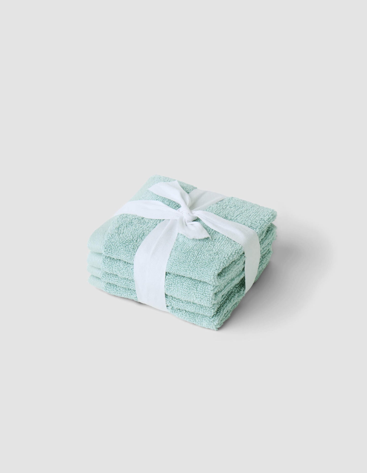 A stack of 4 teal washcloths tied with a white ribbon |Color:Tide