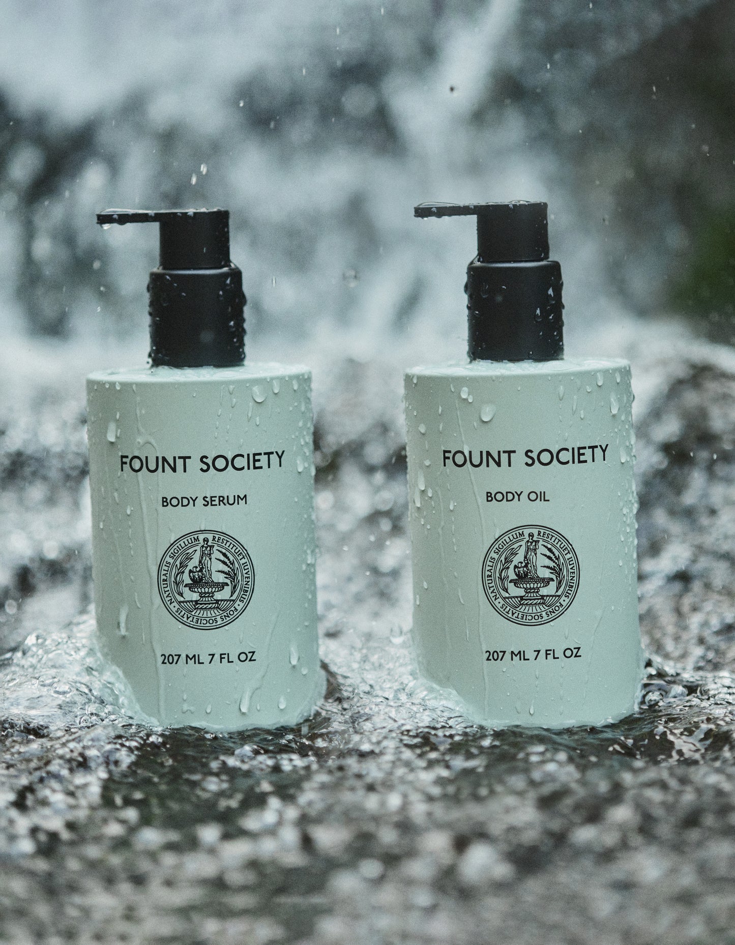 Body Serum and Body Oil bottles with rain dropping down on them.