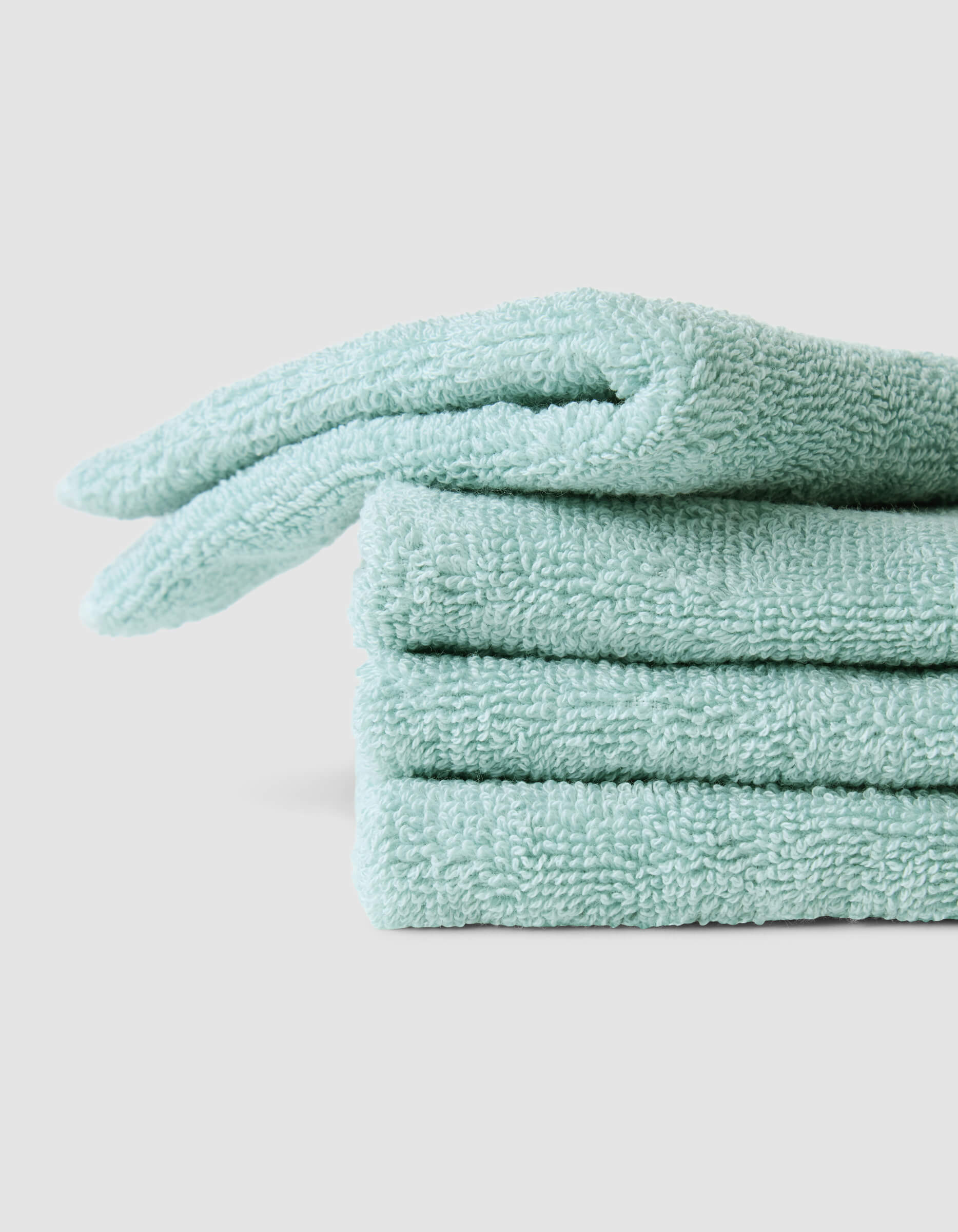 A stack of 4 teal washcloths |Color:Tide