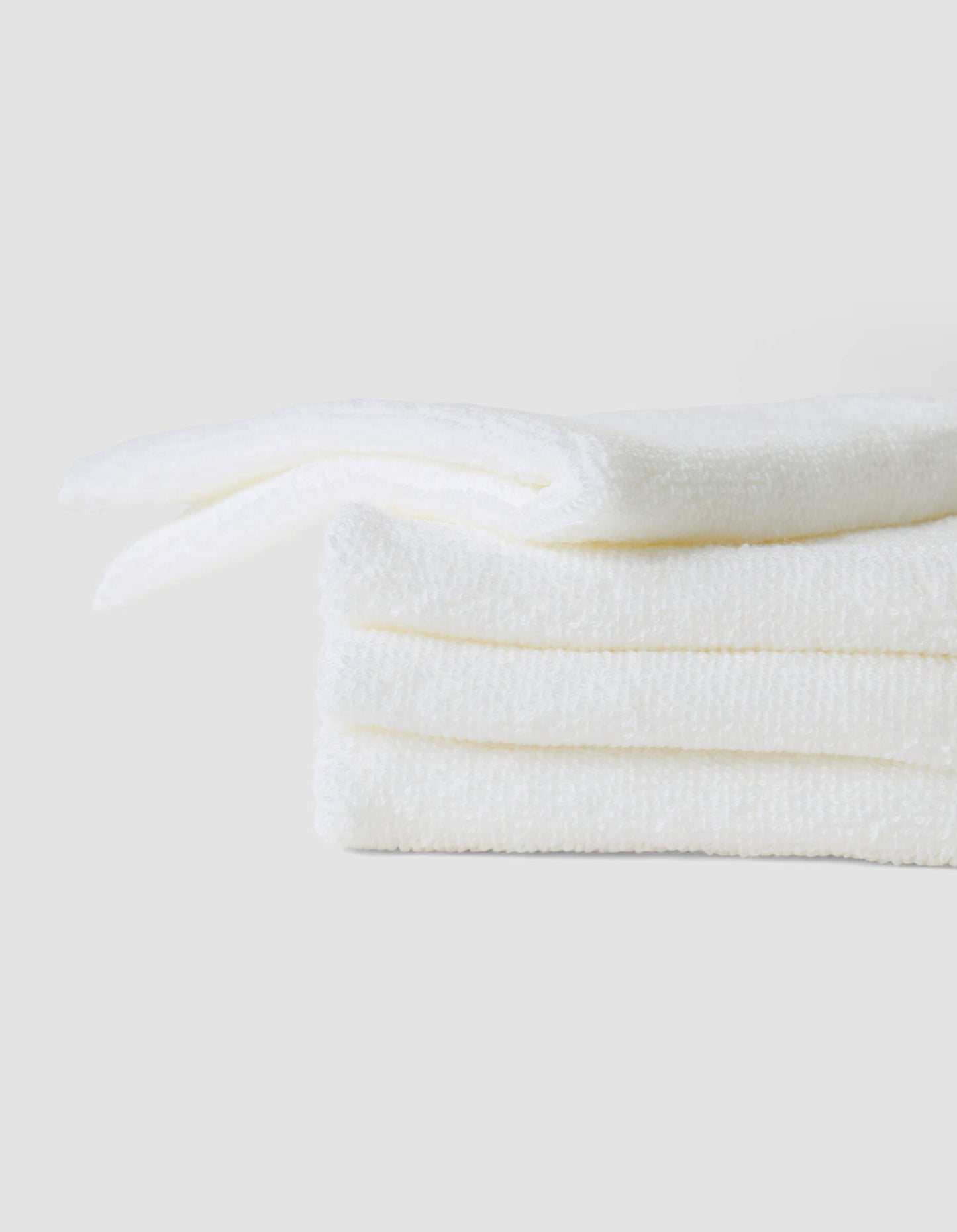 A stack of 4 white washcloths |Color:White