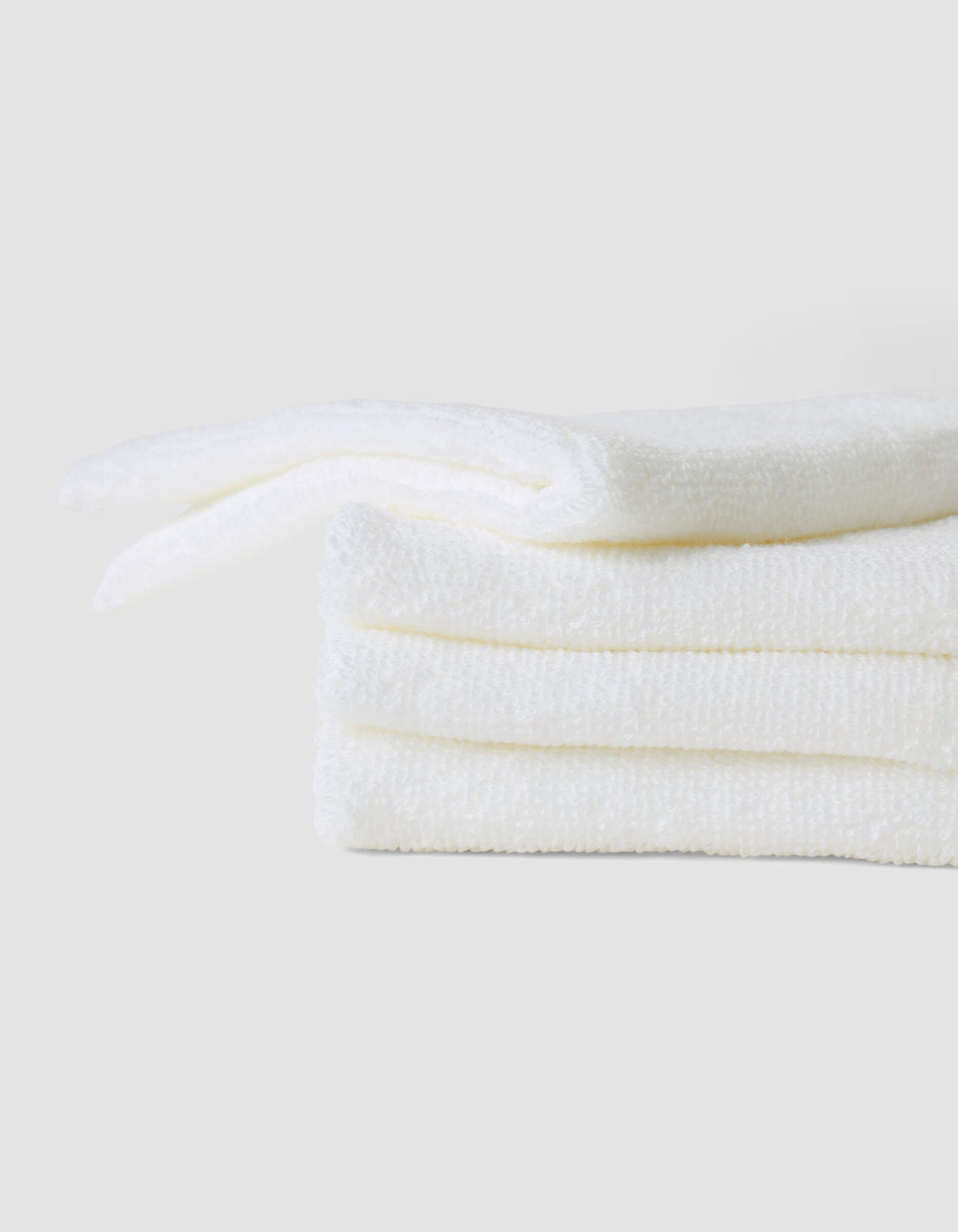 A stack of 4 white washcloths |Color:White