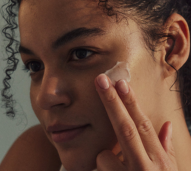 Women applying a Fount product to her face